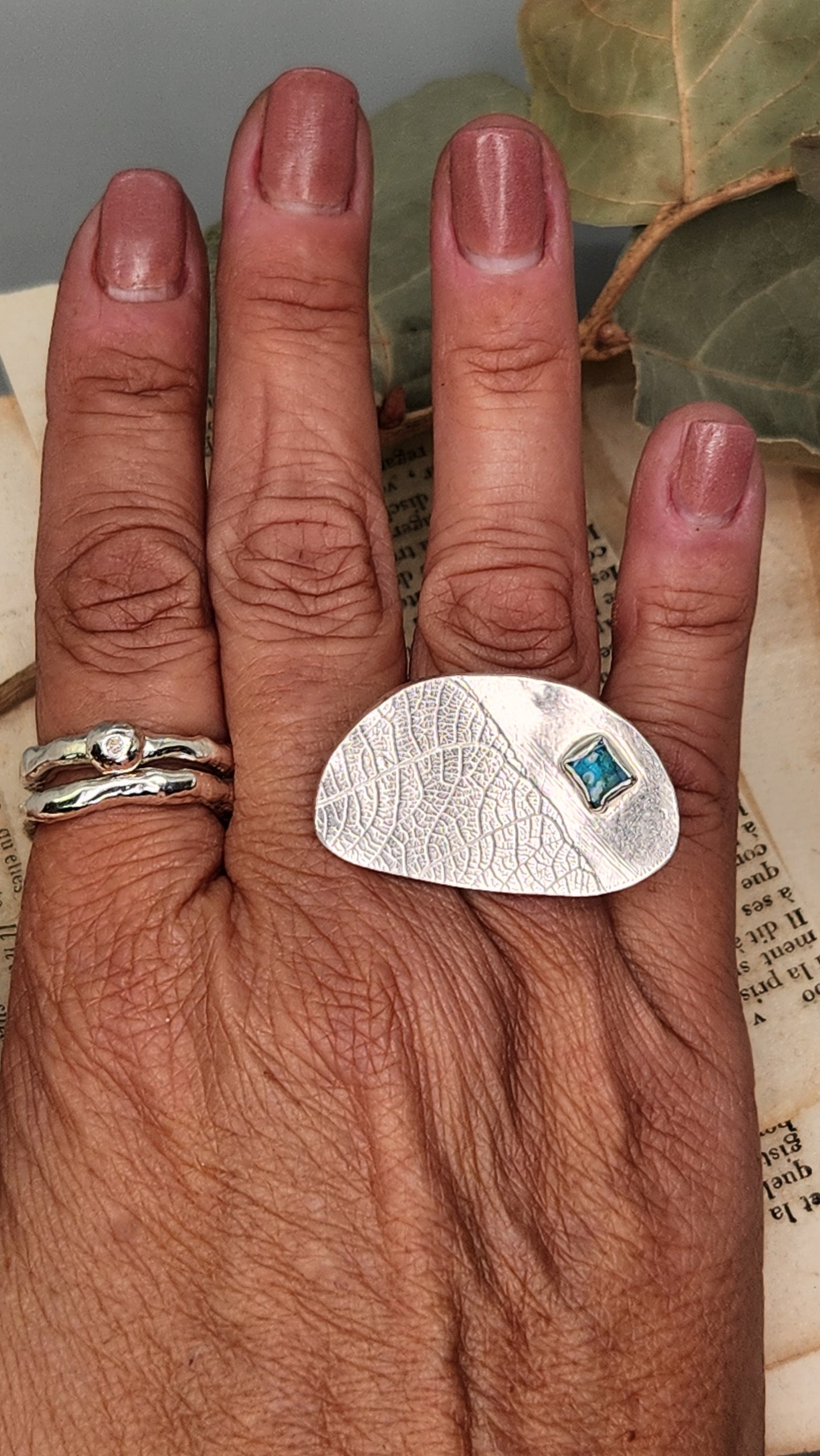 Hollow form statement ring with glass embellishment.