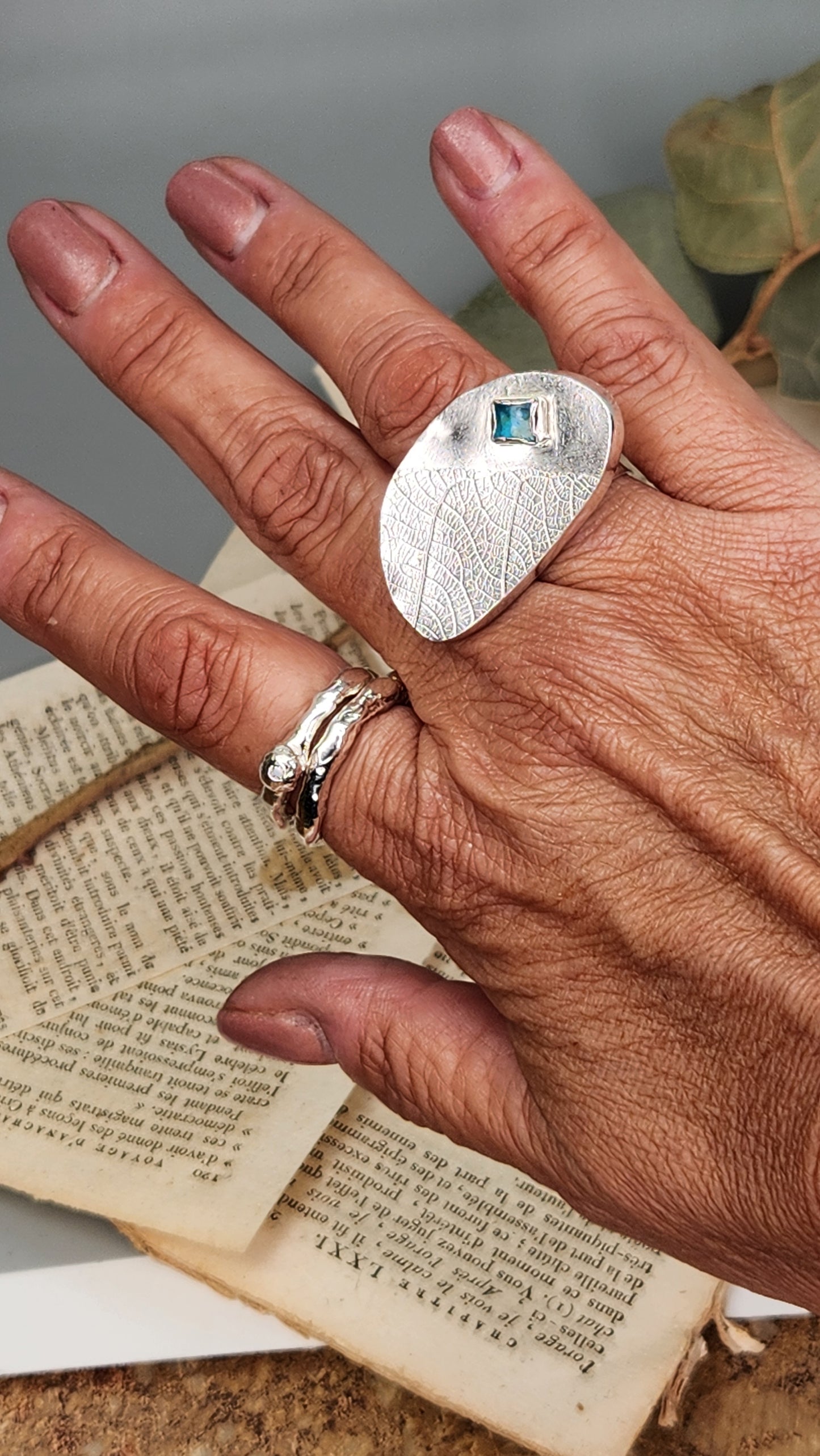 Hollow form statement ring with glass embellishment.