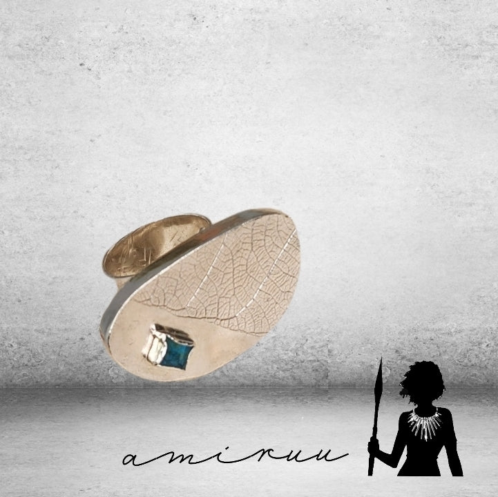Hollow form statement ring with glass embellishment.