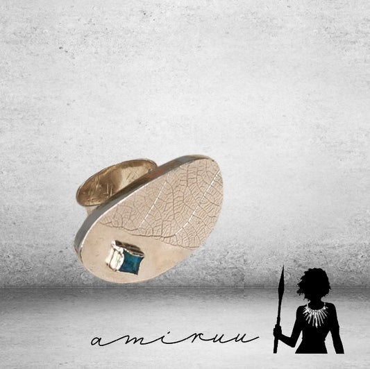 Hollow form statement ring with glass embellishment.